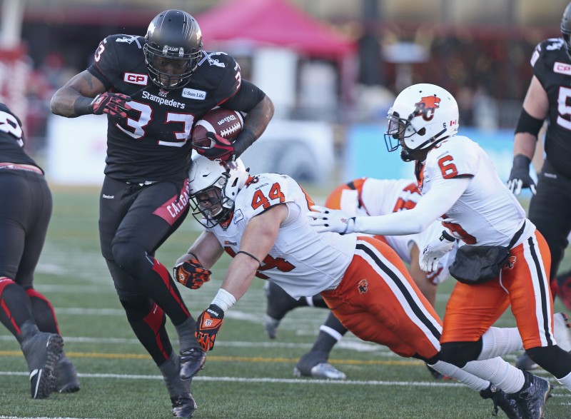 Calgary Stampeders Jerome Messam (33) scores against Adam Bighill (44) of the B.C Lions in first half CFL action west semi-final in Calgary on Sunday, November 15, 2015. (CFL PHOTO - Mike Ridewood)