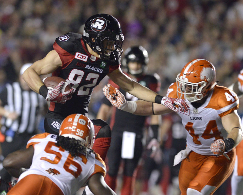 Ottawa Redblacks' Patrick Lavoie (82) jumps to keep B.C. Lions' Adam Bighill (44) and Solomon Elimimian (56) away from the ball during first half CFL action on Thursday, Aug. 25, 2016 in Ottawa. THE CANADIAN PRESS/Justin Tang