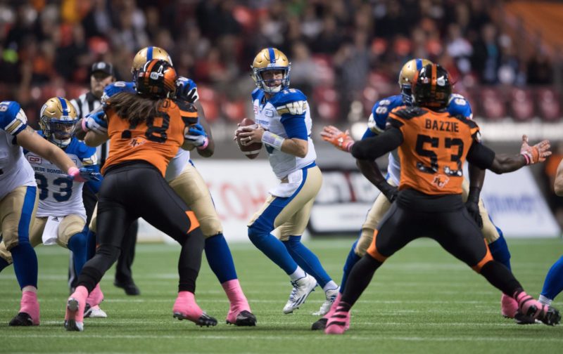 Winnipeg Blue Bombers quarterback Matt Nichols, centre, looks for an open receiver during the first half of a CFL football game against the B.C. Lions in Vancouver, B.C., on Friday October 14, 2016. THE CANADIAN PRESS/Darryl Dyck