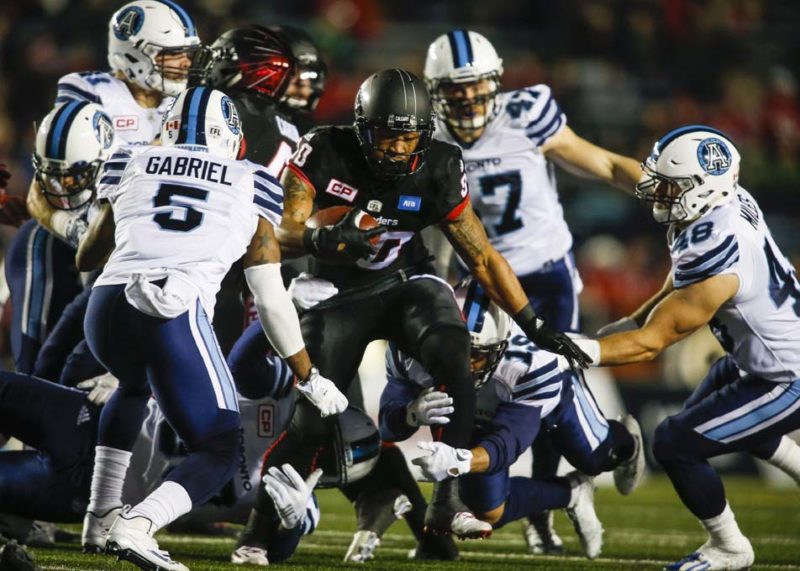Toronto Argonauts' Jermaine Gabriel, left, tries to bring down Calgary Stampeders' Jamal Nixon with his teammates during first half CFL football action in Calgary, Friday, Oct. 21, 2016.THE CANADIAN PRESS/Jeff McIntosh