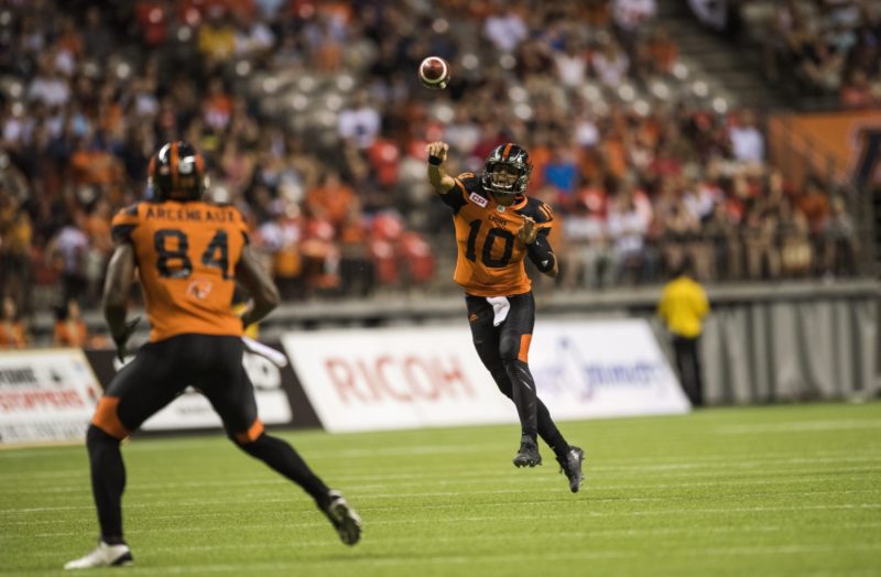 Jonathon Jennings passes the ball to BC Lions wide receiver Emmanuel Arceneaux (84) for the winning touchdown run during second half CFL action in Vancouver, B.C., on Saturday, August 13, 2016. (CFL PHOTO - Jimmy Jeong)