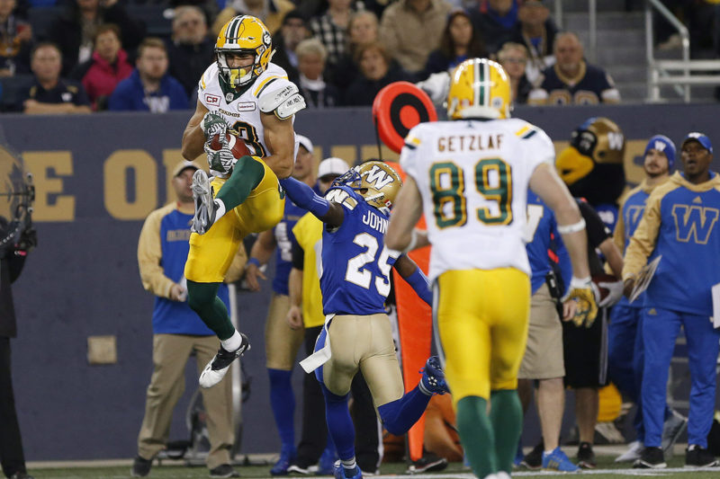 Edmonton Eskimos' Brandon Zylstra (83) snags the pass in front of Winnipeg Blue Bombers' Bruce Johnson (25) during the first half of CFL action in Winnipeg Friday, September 30, 2016. THE CANADIAN PRESS/John Woods