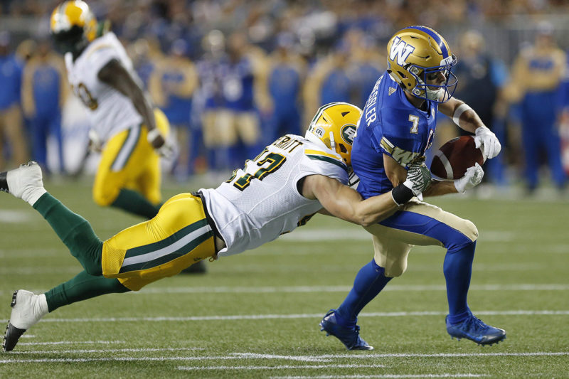 Edmonton Eskimos' JC Sherritt (47) strips the ball from the hands of Winnipeg Blue Bombers' Weston Dressler (7) during the first half of CFL action in Winnipeg Friday, September 30, 2016. THE CANADIAN PRESS/John Woods