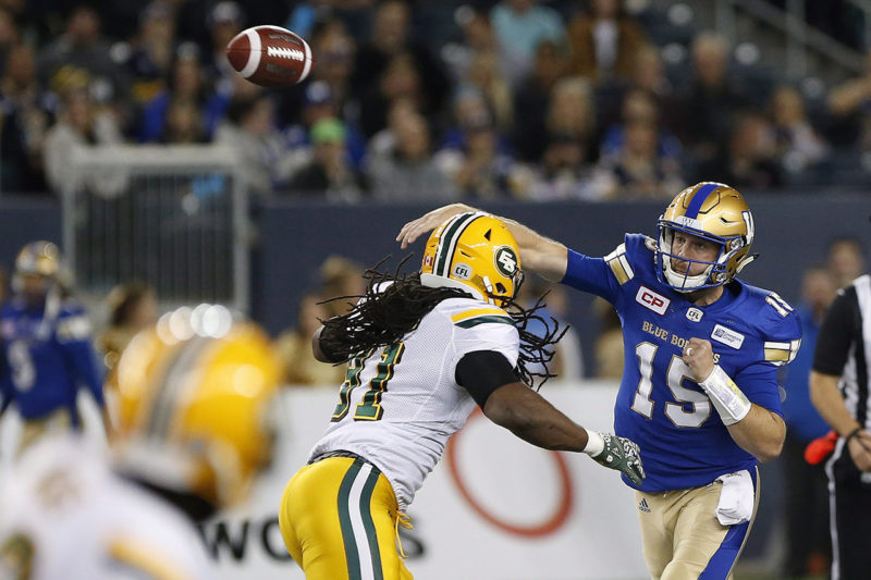 Winnipeg Blue Bombers quarterback Matt Nichols (15) throws under pressure from Edmonton Eskimos' Marcus Howard (91) during the first half of CFL action in Winnipeg Friday, September 30, 2016. THE CANADIAN PRESS/John Woods